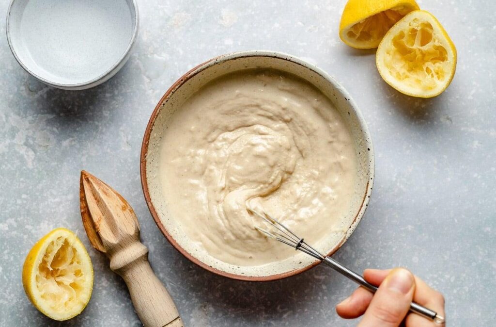 Whisking tahini sauce with lemon