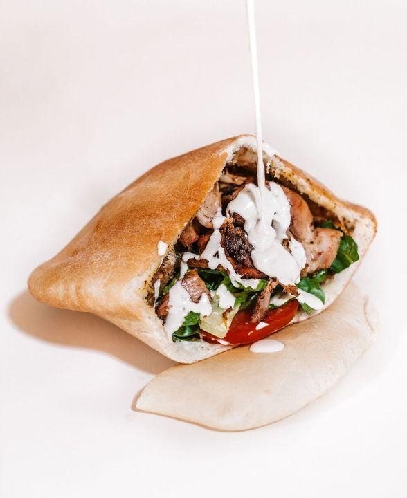 A shawarma sandwich with tahini sauce