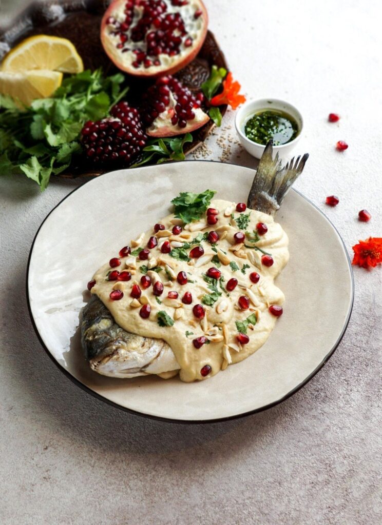 Fish with tahini sauce and pomegranate